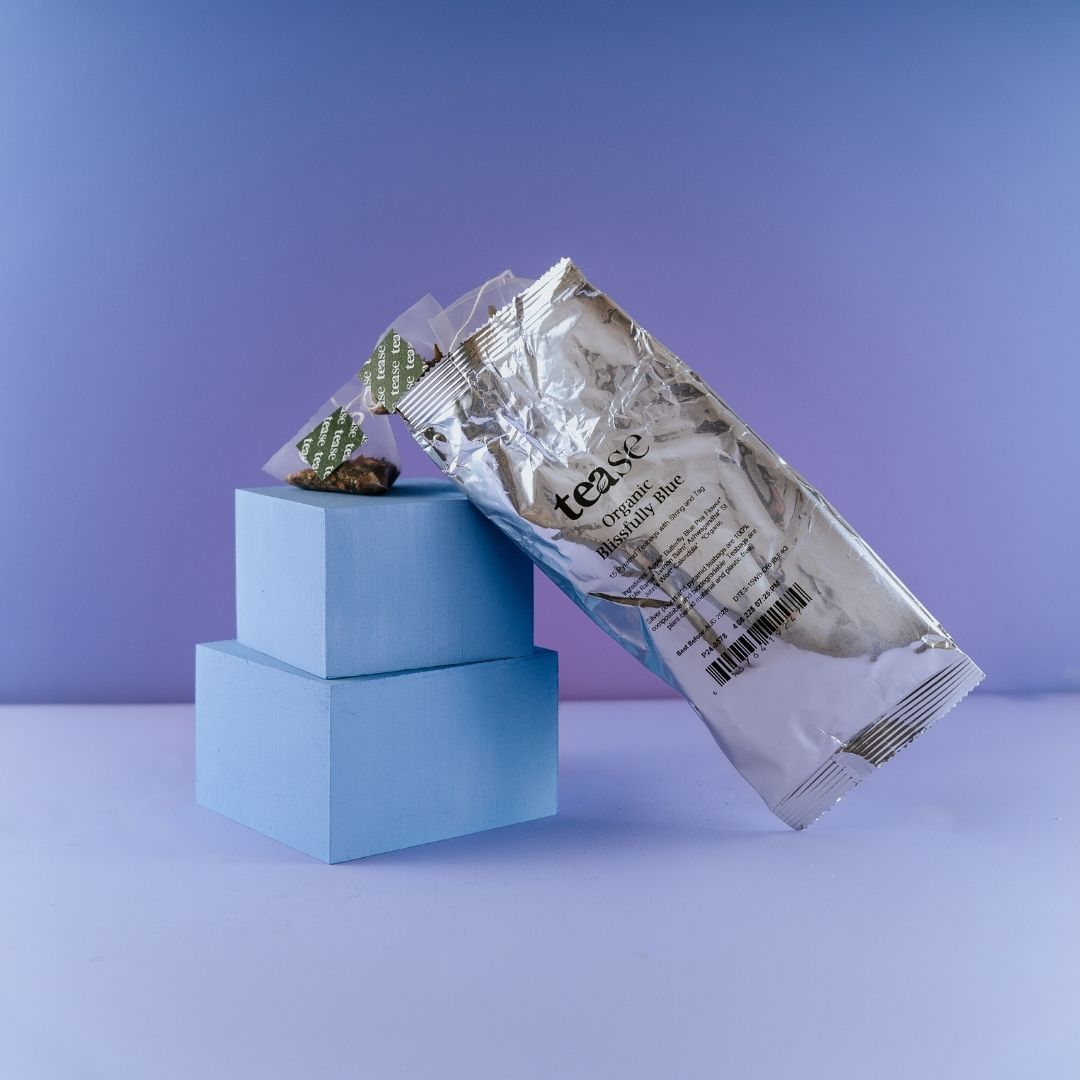 Silver resealable pouch of Tealyra Salon & Spa refill standing on stacked pastel blue blocks against a lavender background.